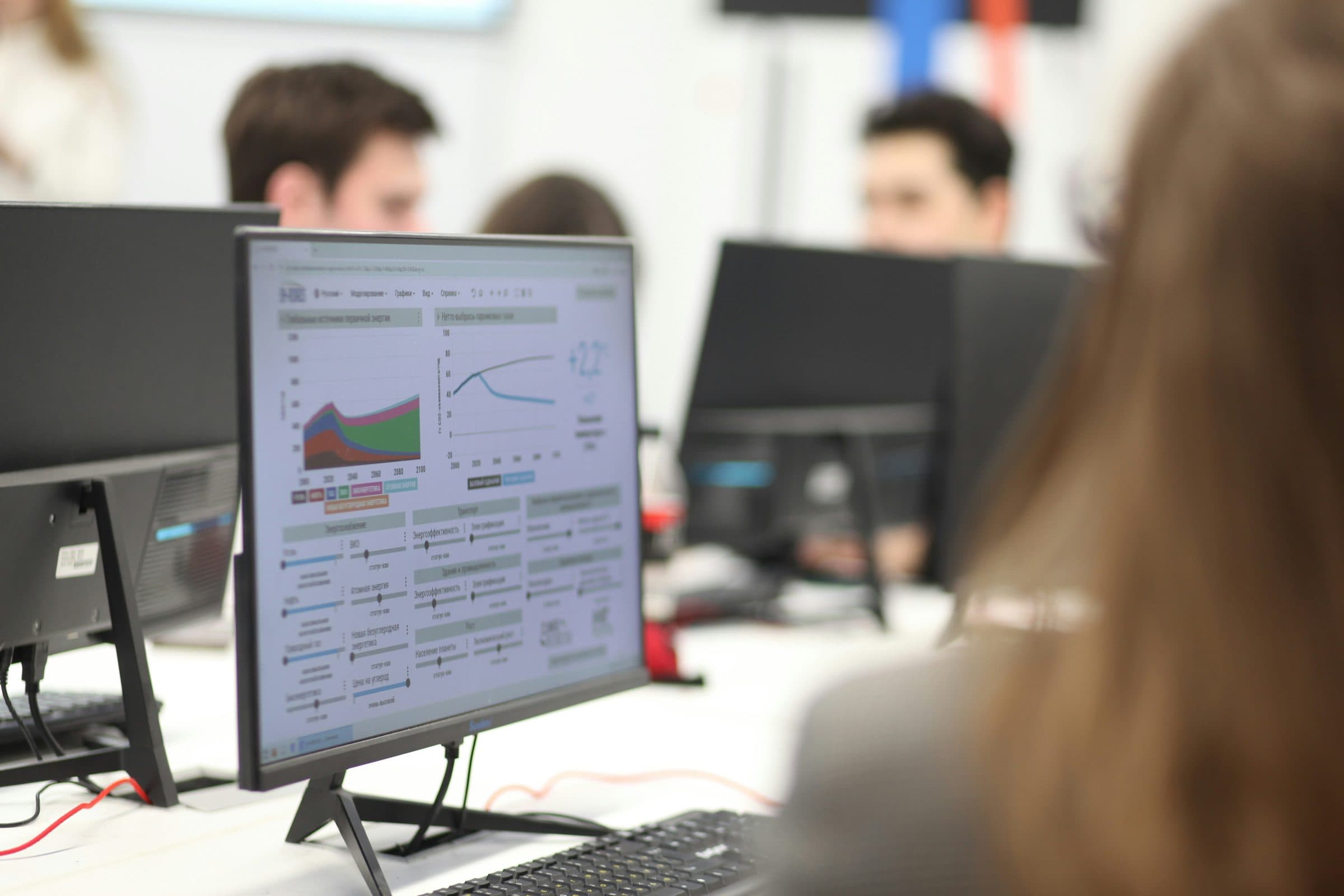 A team reviewing reporting dashboards together on their monitors